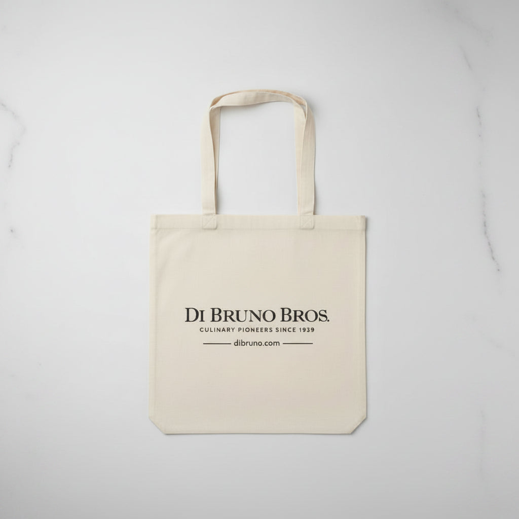 Beige tote bag with 'Di Bruno Bros.' branding on a light gray background