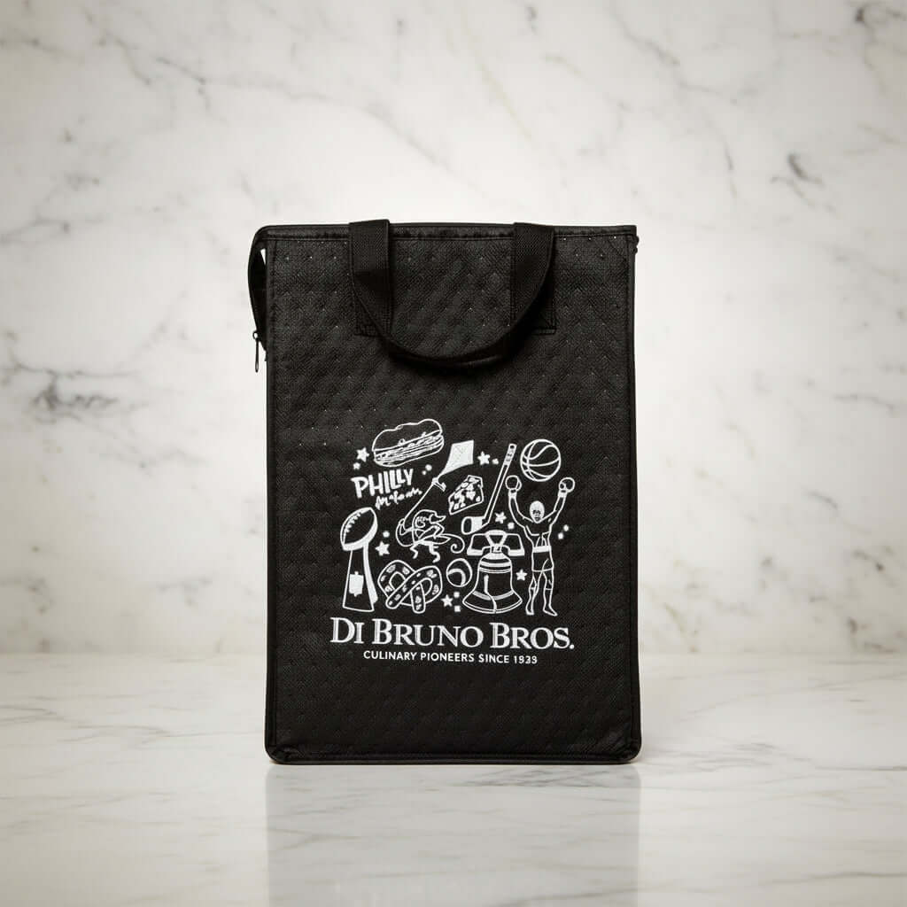 Assorted food products including bags, jars, and bowls on a marble surface with a branded black bag.