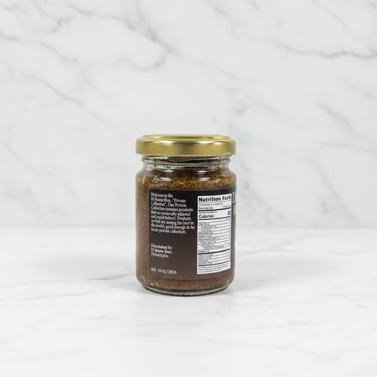 Small glass jar with a gold lid on a black surface