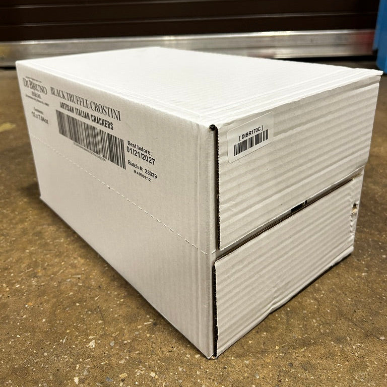 White cardboard box with labels on a concrete floor