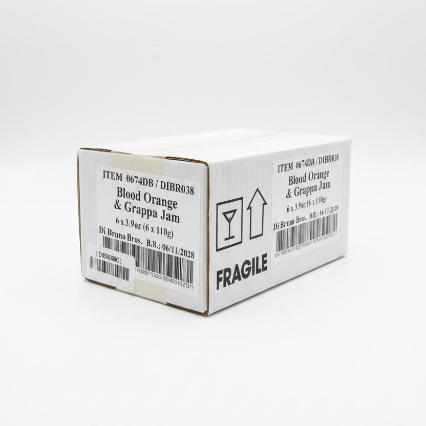 Box of Blood Orange & Grappa Jam with 'Fragile' label on a black surface.
