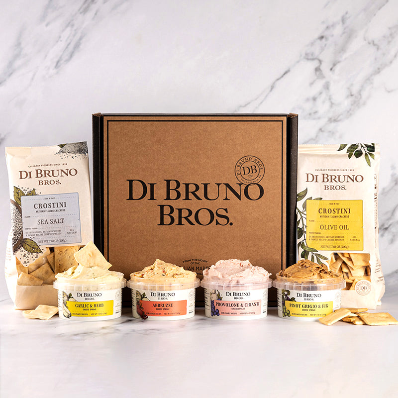 A gourmet gift box from Di Bruno Bros. containing various cheese spreads and crostini crackers.