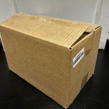 Cardboard box with a label on a black surface