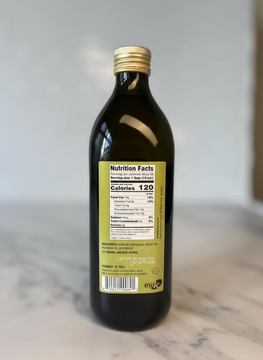 Bottle of olive oil with a nutrition facts label on a marble surface