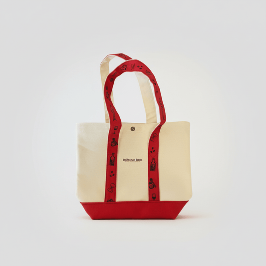 Beige tote bag with red handles and trim on a white background