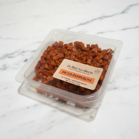 Packaged diced pepperoni on a white surface