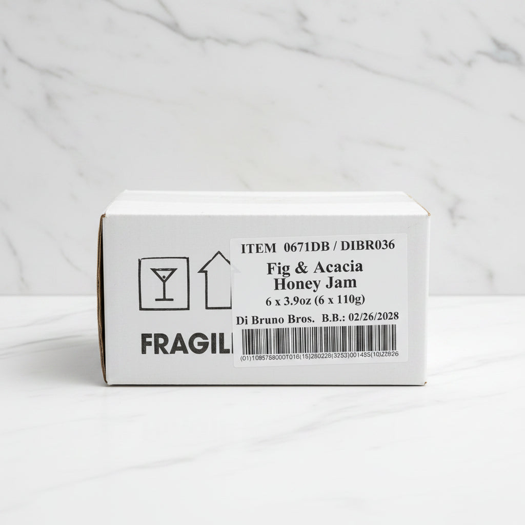 Box of Fig & Acacia Honey Jam with fragile label on a dark surface