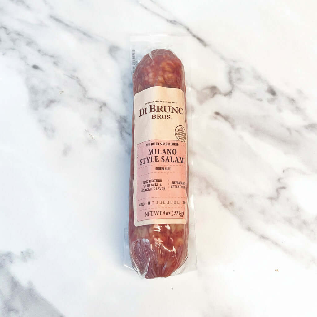Packaged Milano Style Salami from Di Bruno Bros on a marble surface