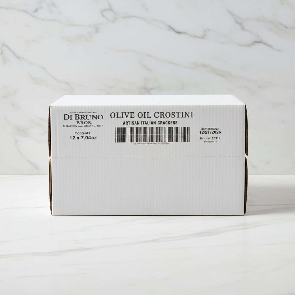 Stack of Di Bruno Bros. olive oil crostini boxes in a warehouse setting