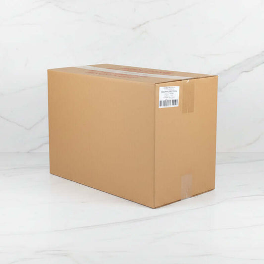 Cardboard box with a label on a concrete floor in a warehouse setting