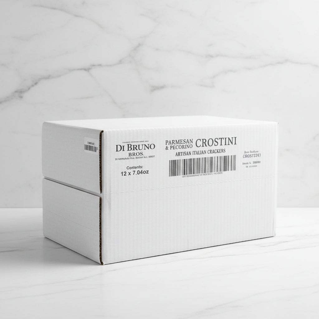 Stack of white boxes with Di Bruno Bros. branding on a conveyor belt in a warehouse.