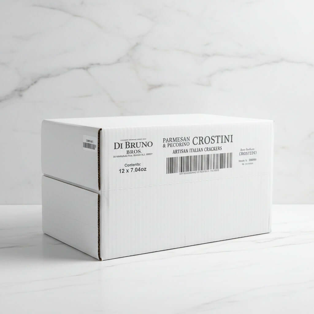 Stack of white boxes with Di Bruno Bros. branding on a conveyor belt in a warehouse.