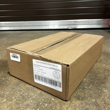 Cardboard box with a label on a concrete floor in front of a metal storage unit.