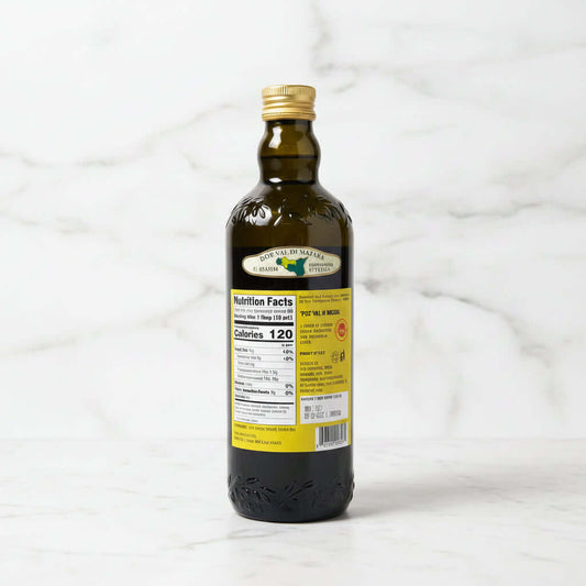 Bottle of olive oil with a label on a dark surface