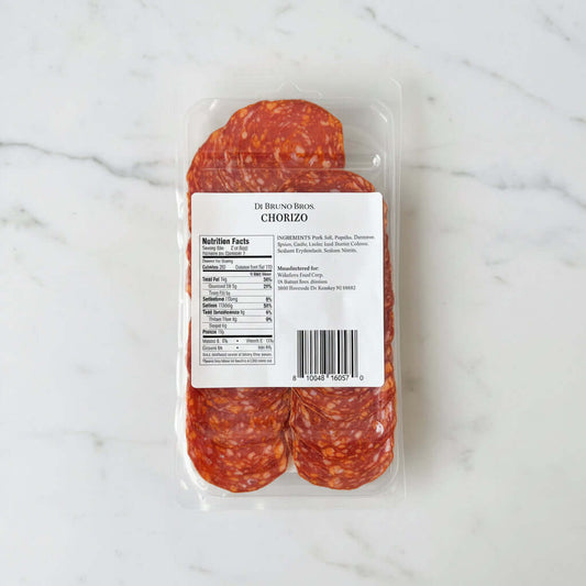 Packaged chorizo on a marble surface