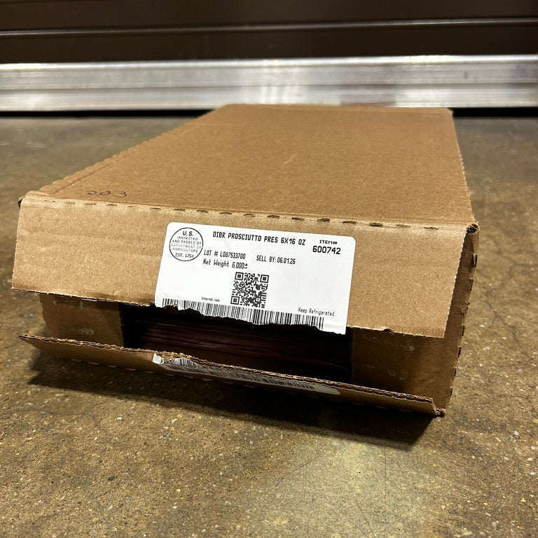 Cardboard box with a label on a concrete floor