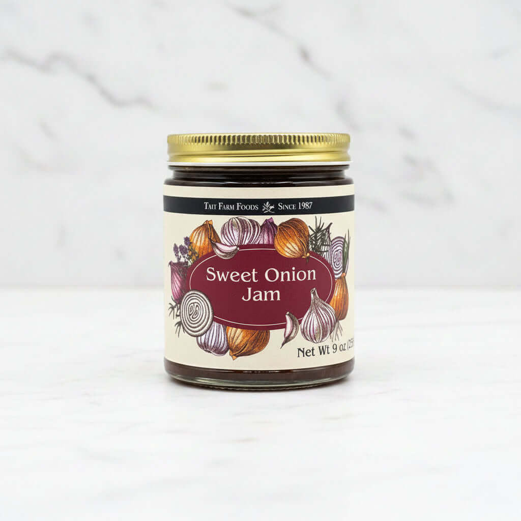 Sweet Onion Jam in a jar with colorful onion illustrations on the label, set on a light marble background.
