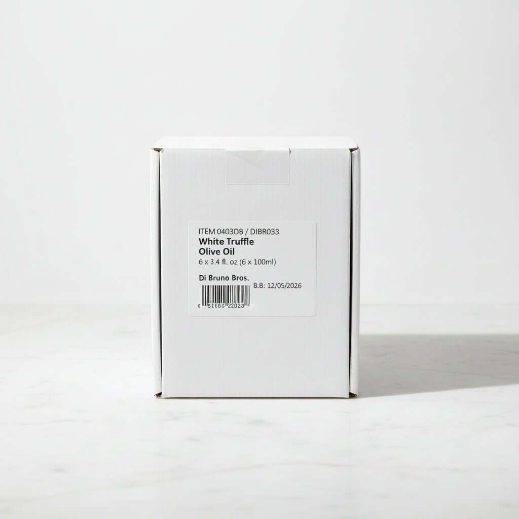 Box of White Truffle Olive Oil on a dark surface with a light gray background