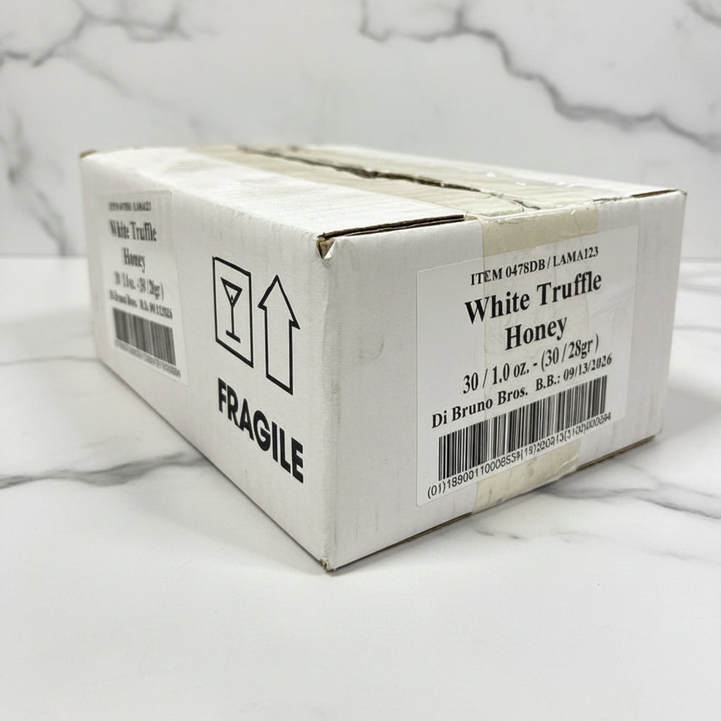 Box of White Truffle Honey with fragile label on a black surface