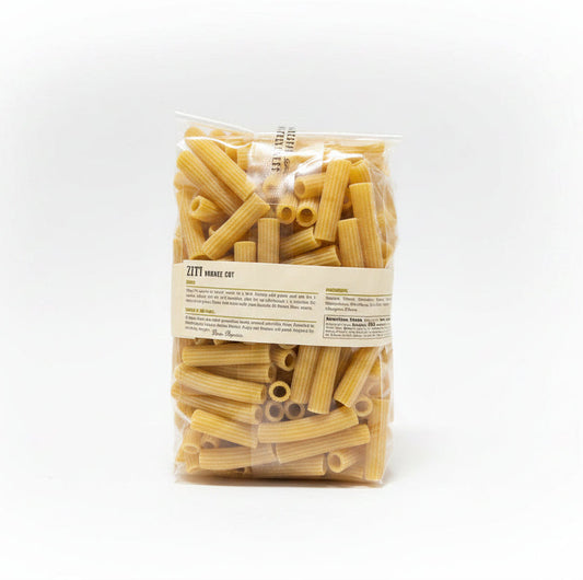 Bag of Ziti pasta with a label on a black surface and gray background