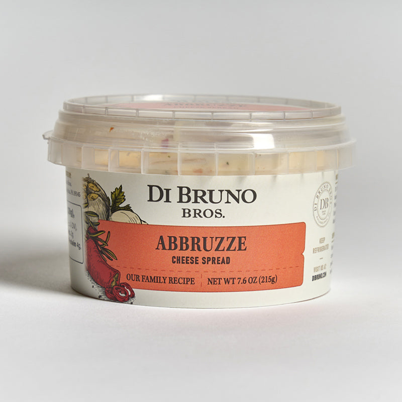 A container of Di Bruno Bros. Abbruzze Cheese Spread on a light background.