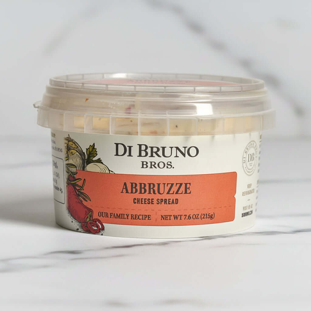 A container of Di Bruno Bros. Abbruzze Cheese Spread on a light background.