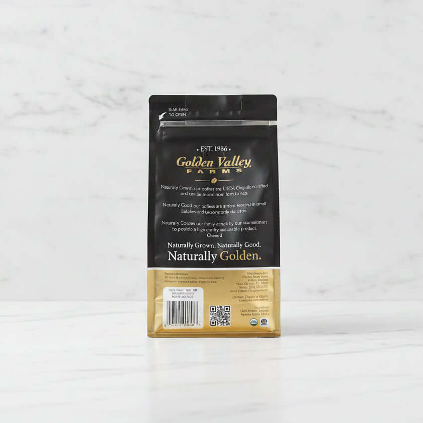 Fightin' Fanatic Roast Organic Coffee, 12-Ounce Bag with black packaging, displayed on a marble surface.