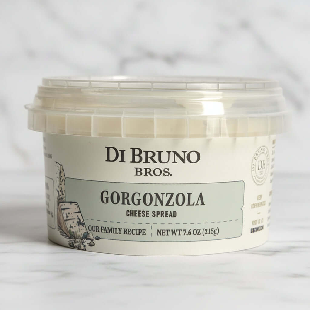 A plastic tub of Di Bruno Bros. Gorgonzola Cheese Spread with a white label featuring the product name and a brief description.