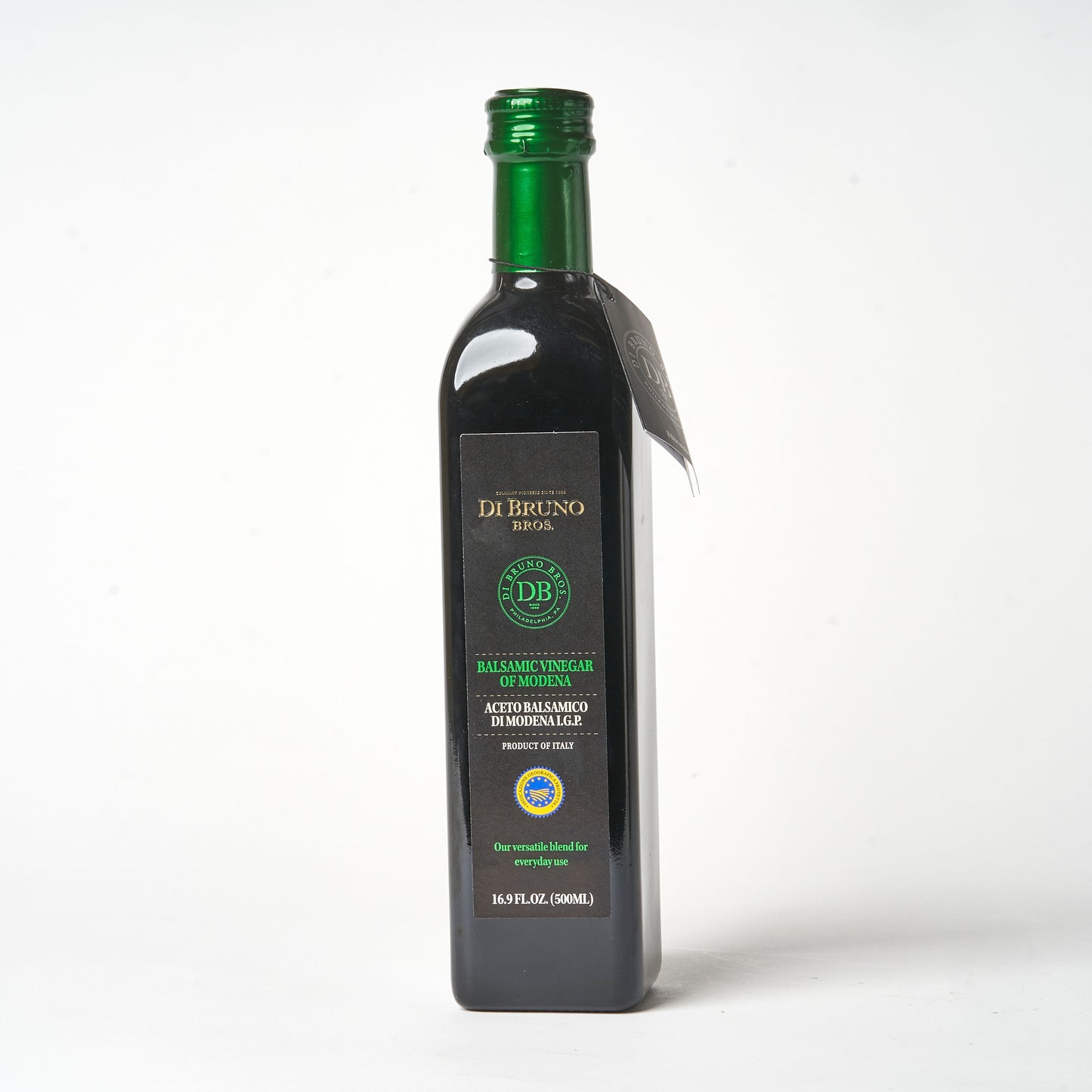 A bottle of Di Bruno Bros. IGP Classico Balsamic Vinegar with a green label and cap, on a white background.