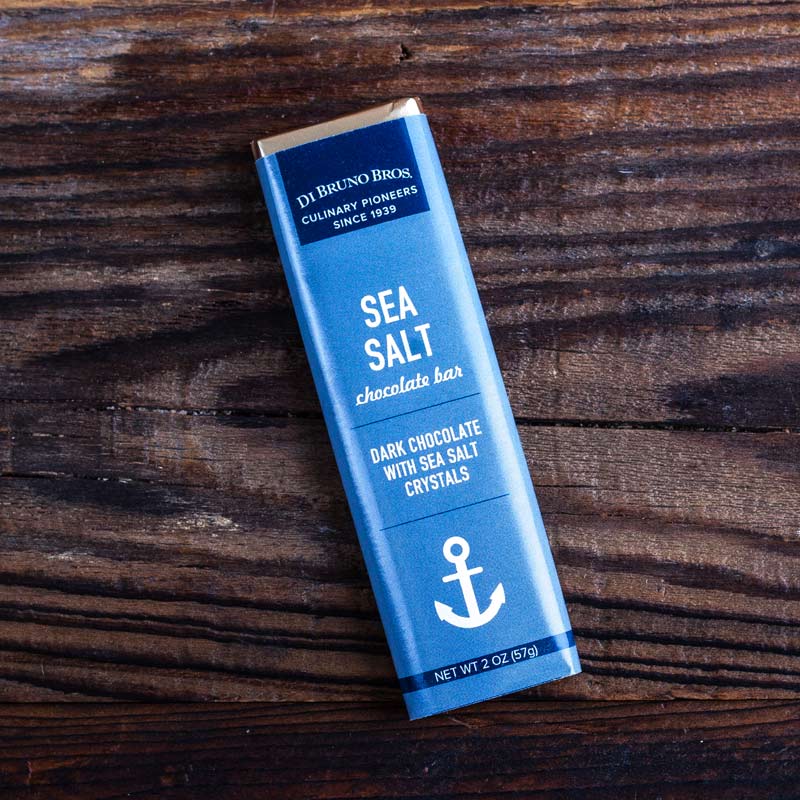 Di Bruno Bros. Sea Salt Chocolate Bar placed on a wooden surface.