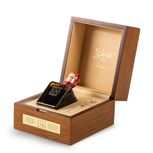 Wooden box with a bottle of Gucci 100 Elixir on a white background