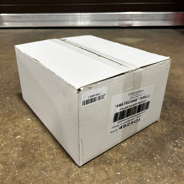 White cardboard box with a label on a concrete floor
