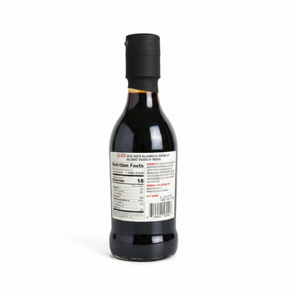 Bottle of sauce with a label on a dark surface