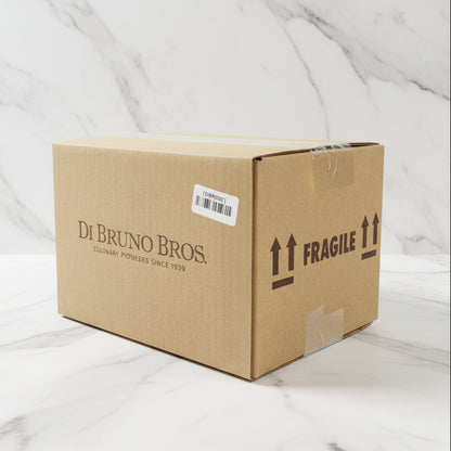 Cardboard box with 'Di Bruno Bros.' branding and 'Fragile' label in a warehouse setting
