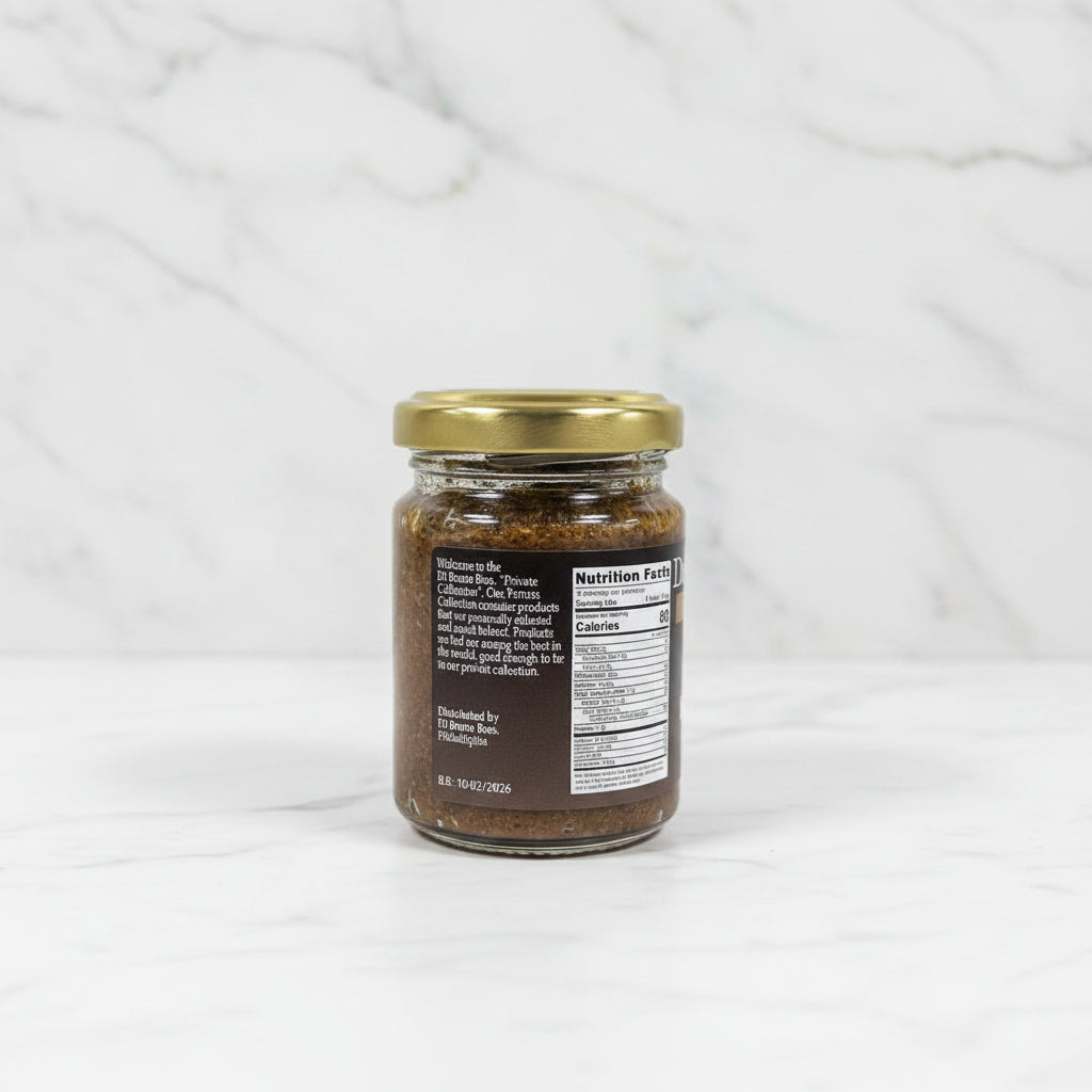Small glass jar with a gold lid on a black surface