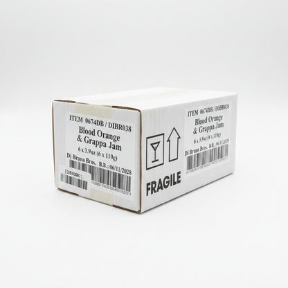 Box of Blood Orange & Grappa Jam with 'Fragile' label on a black surface.