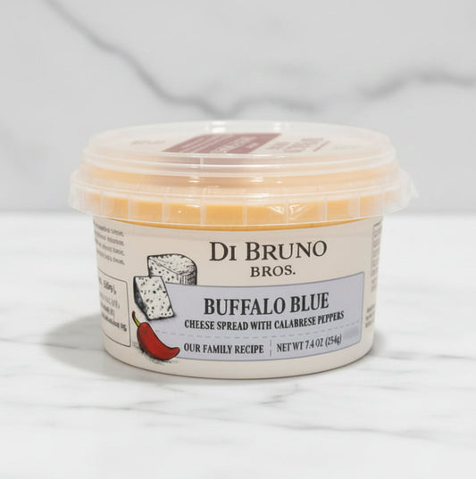 Container of Di Bruno Bros. Buffalo Blue cheese spread on a white surface with a gray background