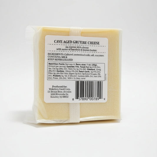 Packaged cave-aged Gruyère cheese with a label on a gray background