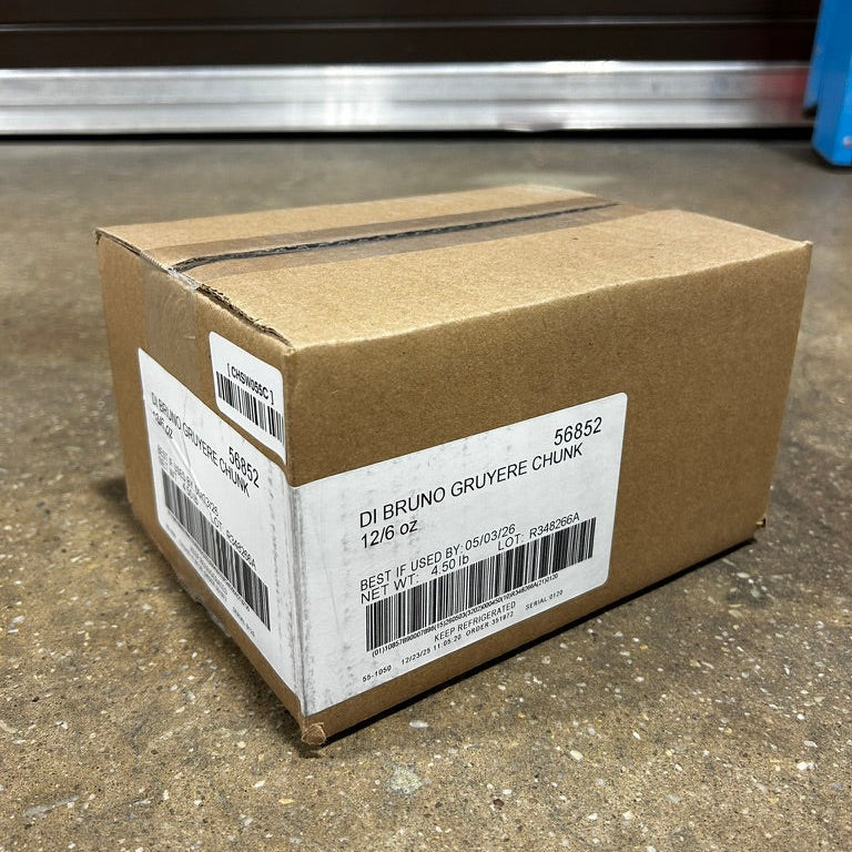 Cardboard box with a label on a concrete floor