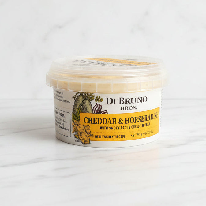 Container of De Bruno Bros Cheddar & Horseradish on a dark surface with a white background