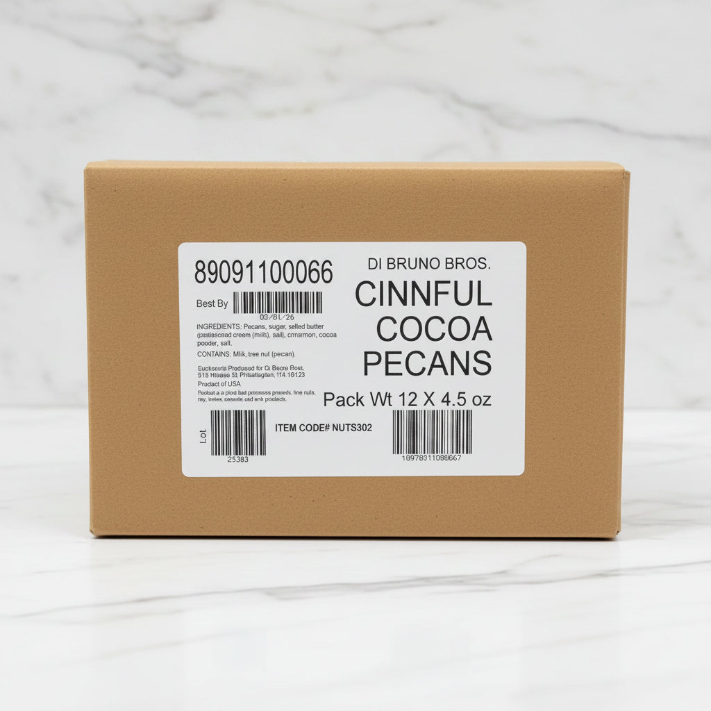 Cardboard box with a label for DI Bruno Bros. Cinnful Cocoa Pecans on a black surface.