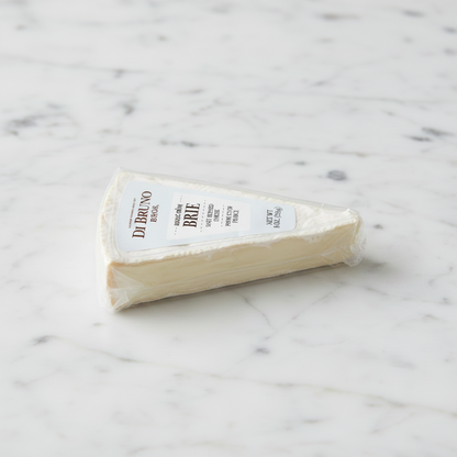A wedge of Di Bruno Brie cheese on a white background with a small printed number below it.