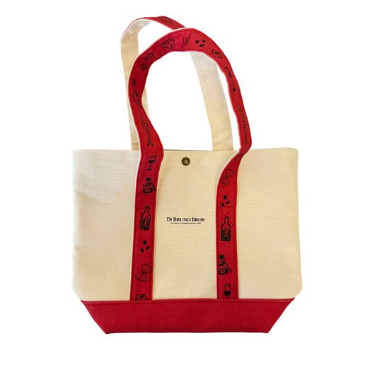 Beige tote bag with red handles and trim on a white background