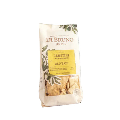 Packaged crostini crackers in a transparent bag with branding and flavor information, on a light background.