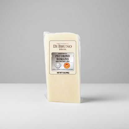 Block of Romano cheese with Di Bruno Bros packaging on a white background