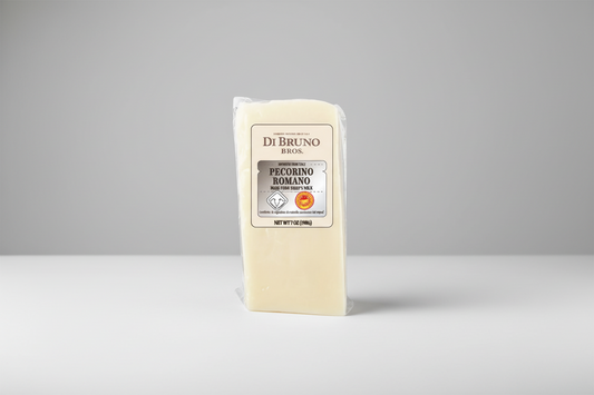 Block of Romano cheese with Di Bruno Bros packaging on a white background