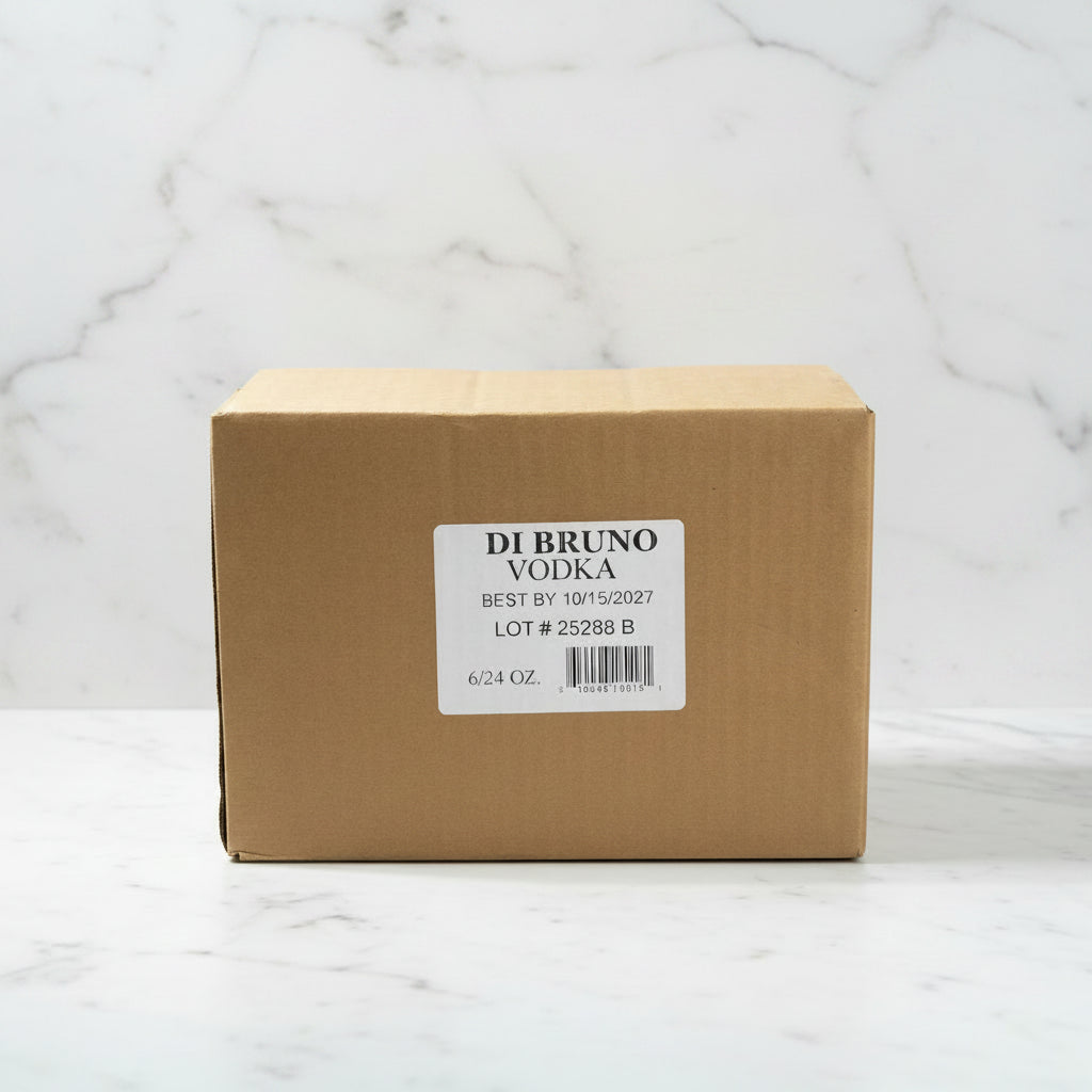 Cardboard box of Di Bruno Vodka on a black surface with warehouse background
