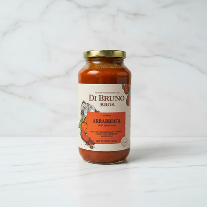 Jar of Di Bruno Bros. Arrabbiata sauce on a black surface with a white background
