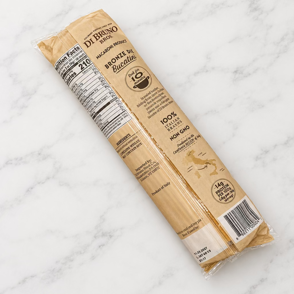 A package of Di Bruno Bros bucatini, shown on a white surface with the back of the packaging visible.