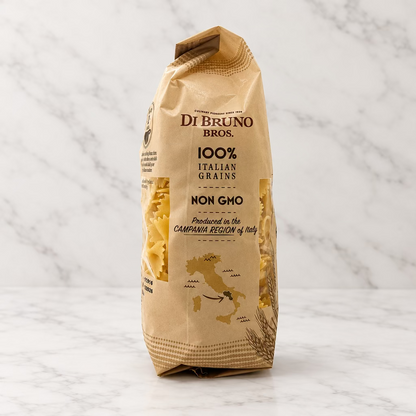 A bag of Di Bruno Bros. 100% Italian Grains Non Gho pasta, shown standing upright against a plain white studio background.
